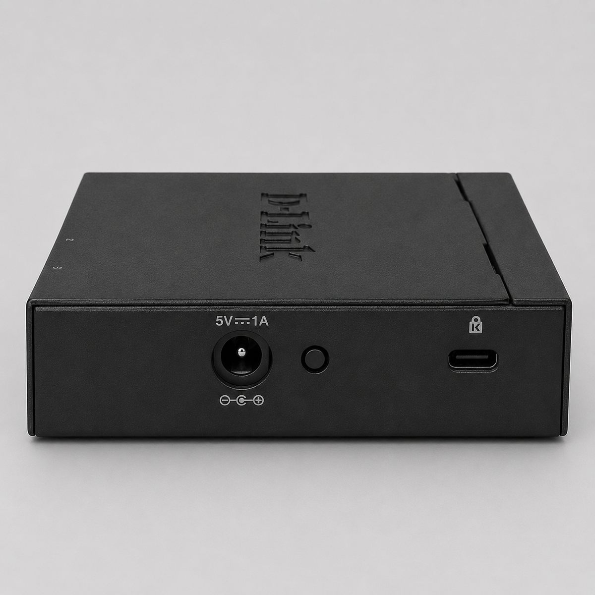 Rear view of D-Link DGS-105 unmanaged 5 port switch showing power input and security lock slot