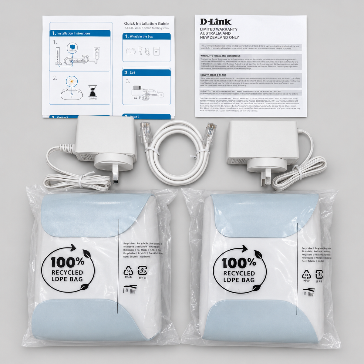 D-Link AX3000 M30-2PK mesh Wi-Fi system package contents including routers, power adapters and ethernet cable