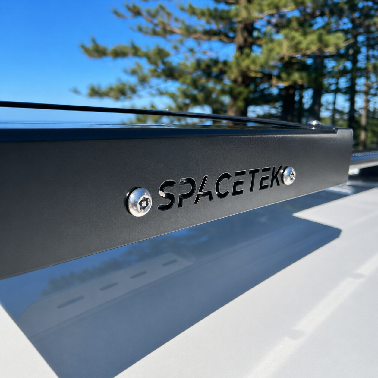 Close-up detail of the Spacetek Stealth Mount for Starlink Mini, featuring laser-cut branding, black powder-coated aluminium construction, and stainless steel fasteners.