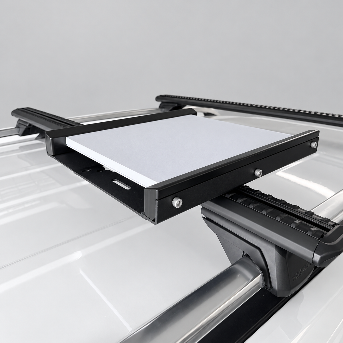 Angled view of Starlink Mini In-Motion aluminium mount showing CNC-machined rails, mounting hardware and roof rack installation